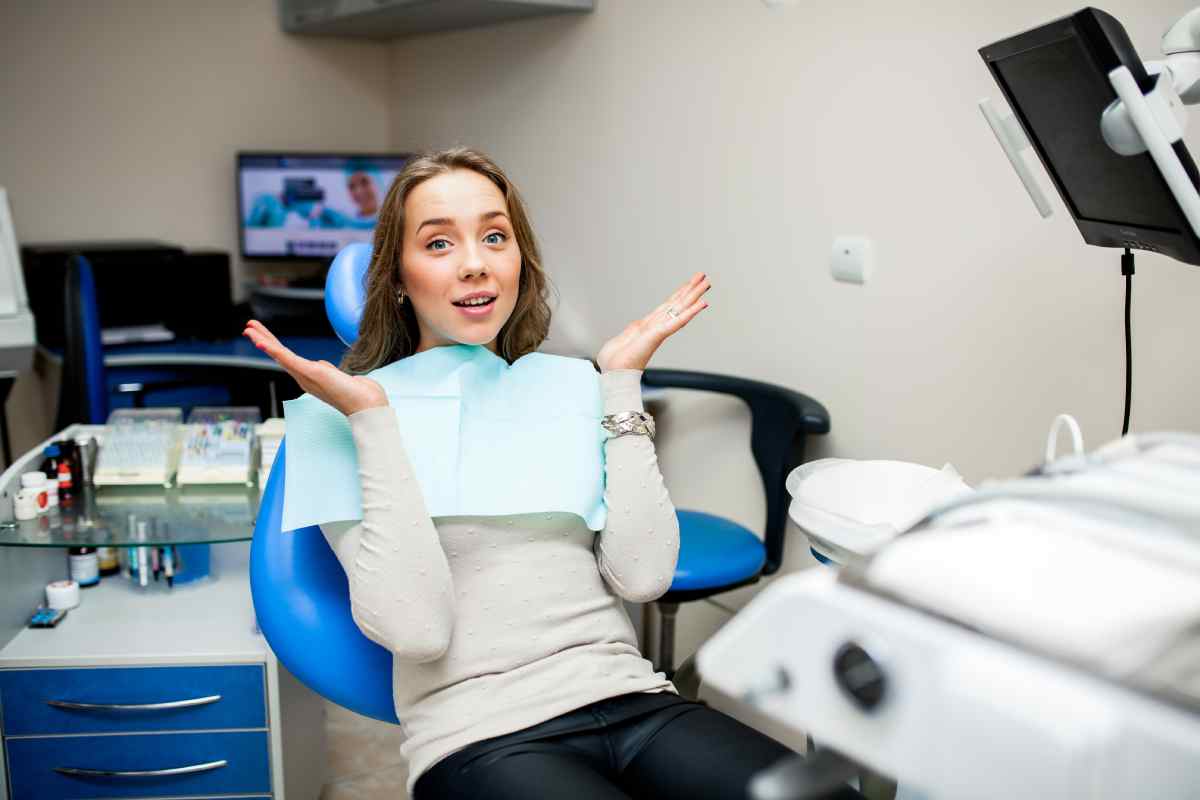 Women sitting in a dental chair with a inquisitive look on her face.